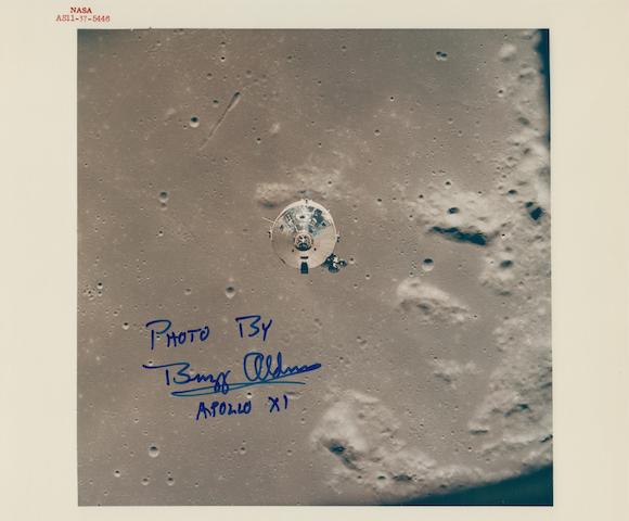 COLUMBIA AND EAGLE SEPARATE THE BEGINNING OF MAN'S FIRST LUNAR LANDING Color photograph, 8 x 10 inches with red NASA identification number at upper left.