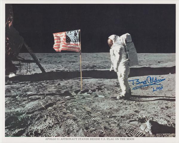 ALDRIN WITH THE STARS AND STRIPES Color photolithograph, 8 x 10 inches with NASA descriptive text along the lower border and on verso.