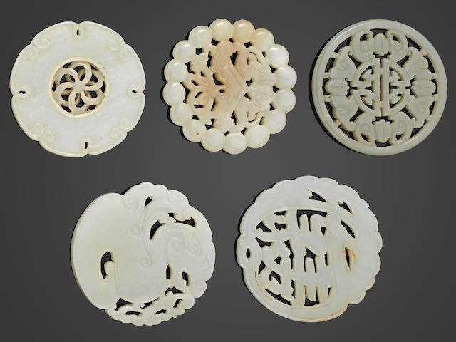 A group of five reticulated circular jade plaques Late Qing/Republic period