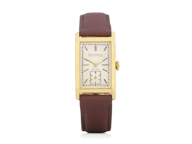 Patek Philippe. An extremely rare 18K gold eight-day manual wind rectangular wristwatch and a 14K gold braceletsold June 21st, 1932