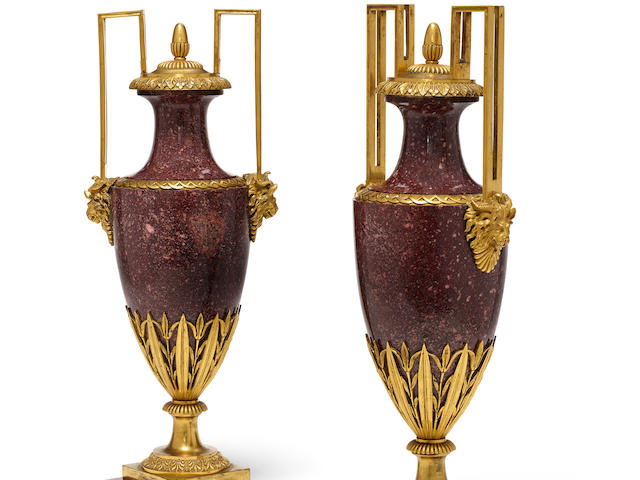 A pair of good quality Louis XVI style gilt bronze mounted porphyry covered urns 19th century