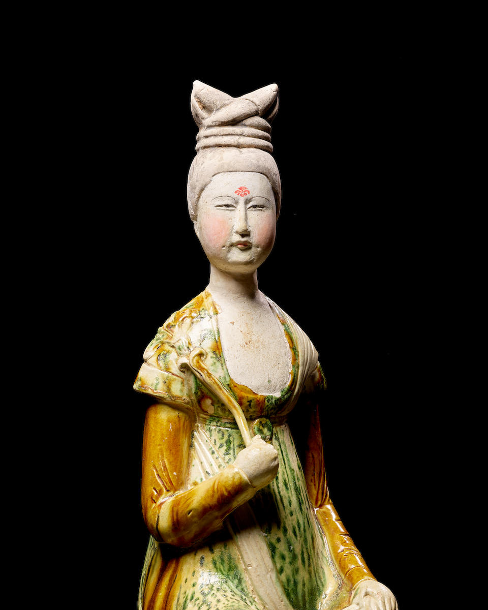 A RARE SANCAI-GLAZED POTTERY FIGURE OF A COURT LADY Tang dynasty