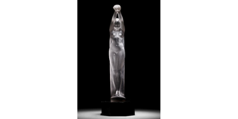 Ren&#233; Lalique (1860-1945) Grande Nue Bras Lev&#233;sMarcilhac 835, model introduced 1921clear and frosted glass, lacquered wood pedestal,  engraved 'R. LALIQUE FRANCE'height of glass 23 1/4in (59cm); overall height mounted on wood pedestal 24 1/4in (61.5cm); width 5in (13cm); depth 3 1/2in (9cm)