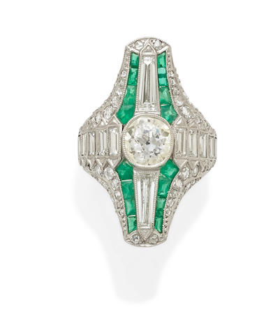 A diamond, emerald and platinum ring
