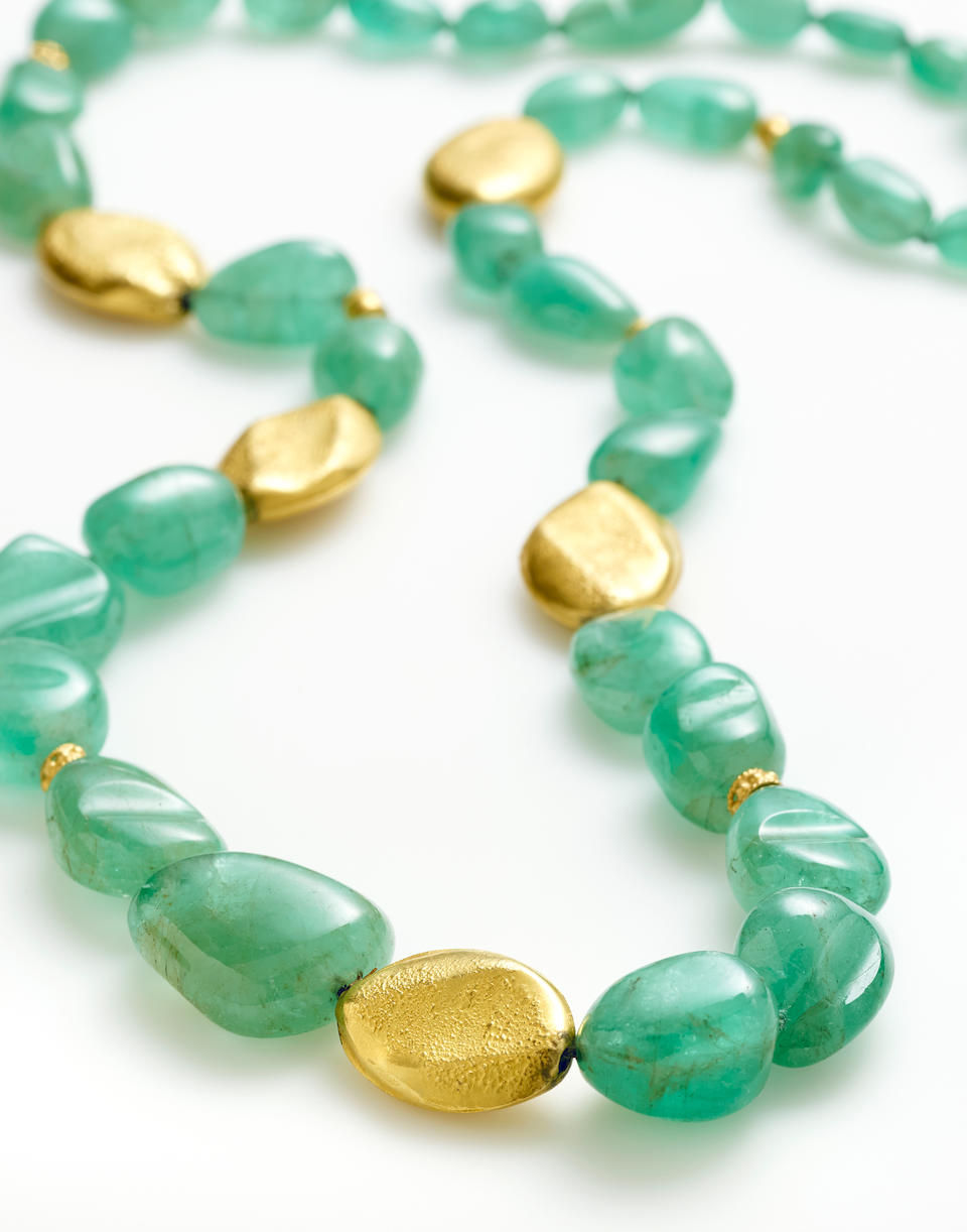 An emerald and gold bead necklace
