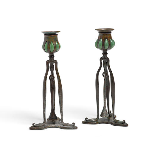 Tiffany Studios (1899-1919) Pair of Candlesticks with Snufferscirca 1910Favrile glass, bronze, stamped 'Tiffany Studios New York 1212'height 10 in (25cm)