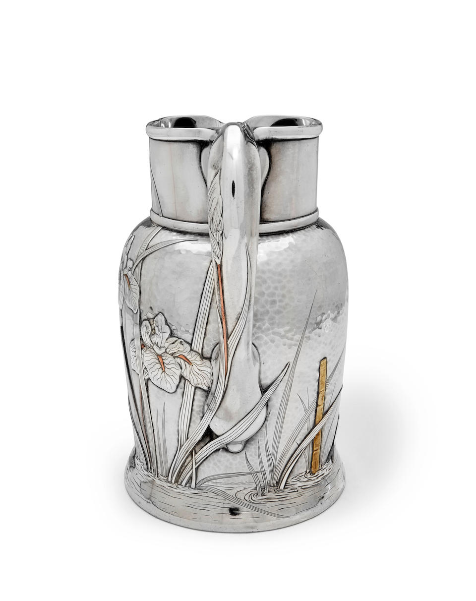 Tiffany & Co. (Founded 1837) Water Pitchercirca 1880silver and mixed-metals, in the Japanesque taste, spot-hammered with applied decoration, stamped 'Tiffany & Co. Makers 5051/ Sterling Silver/8280/925-1000' and initial M for Edward C. Moore, 1873-91height 9in (23cm)gross weight 36oz