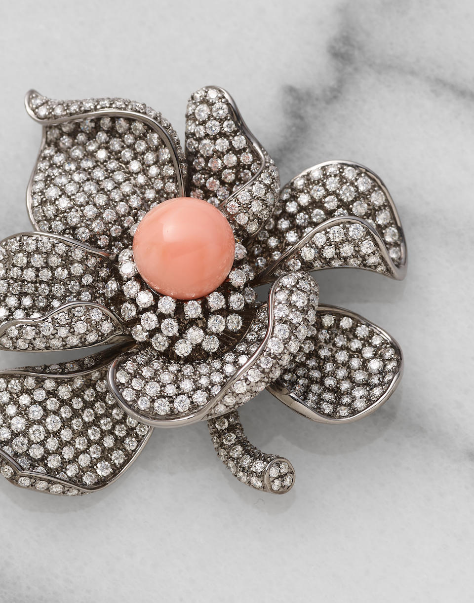 A conch pearl and diamond pendant/brooch