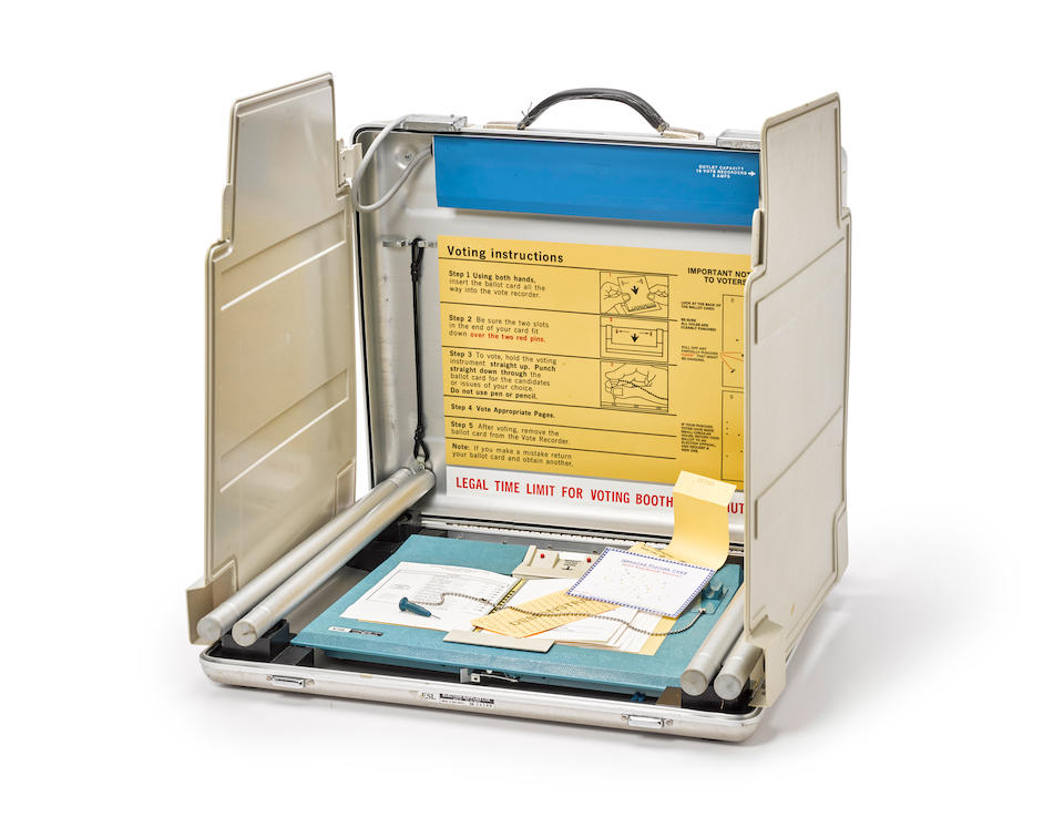 THE HANGING CHAD: FLORIDA, 2000. Florida voting machine, in portable aluminum case with specimen ballots from the 2000 Presidential election,
