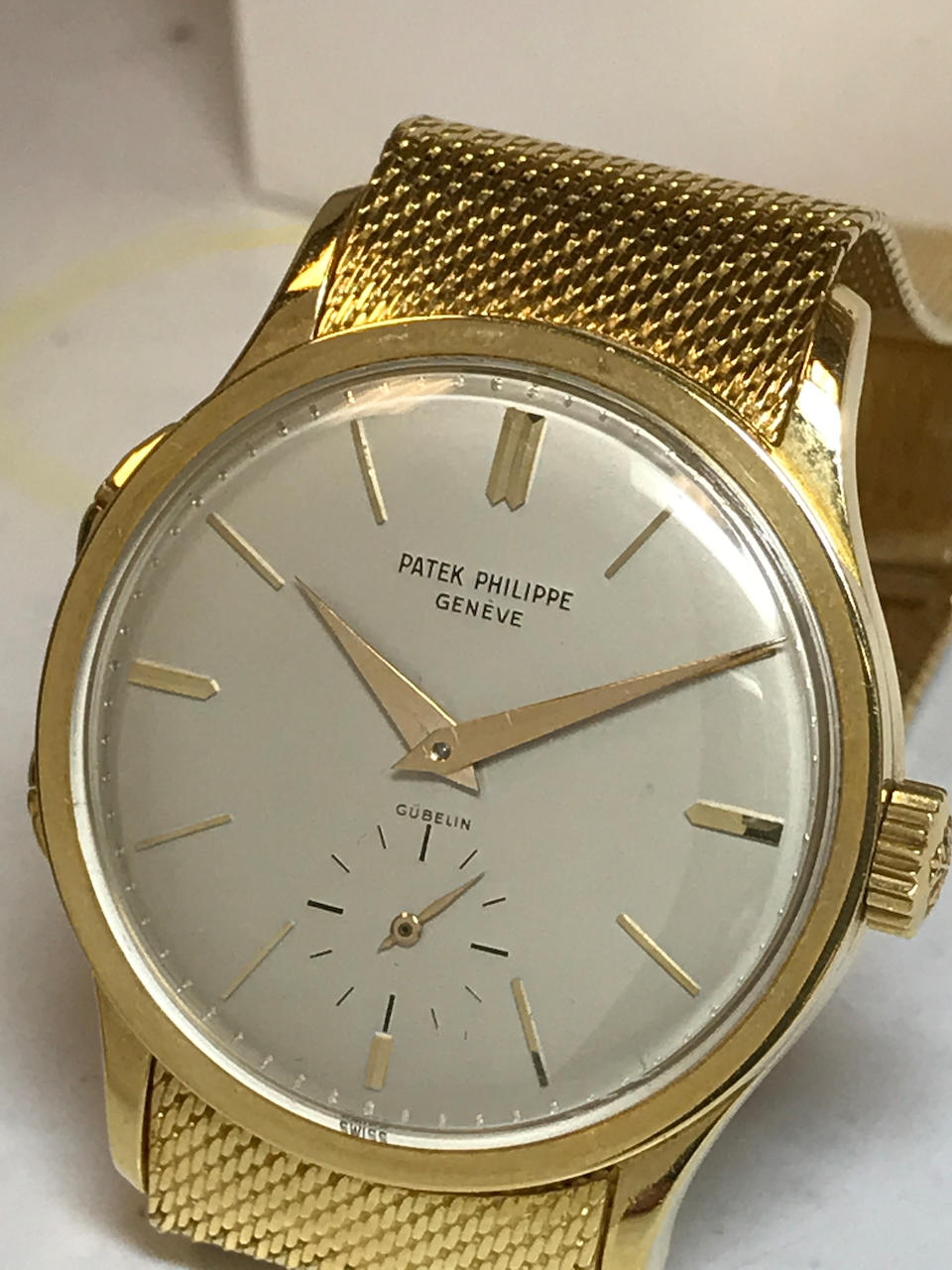 Patek Philippe. A fine and rare 18K gold dual time zone wristwatch with independently adjustable hour hand and an 18K gold braceletRetailed by G&#252;belin Ref: 2597, 1961
