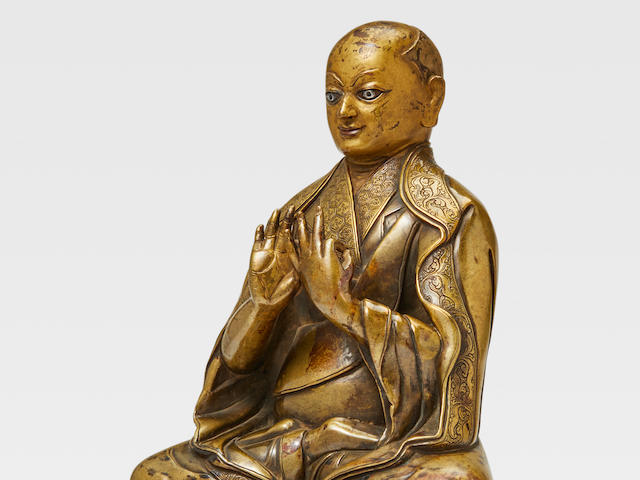 A SILVER AND COPPER INLAID BRASS FIGURE OF DRAKPA GYALTSEN&#160; TSANG, CENTRAL TIBET, 15TH CENTURY