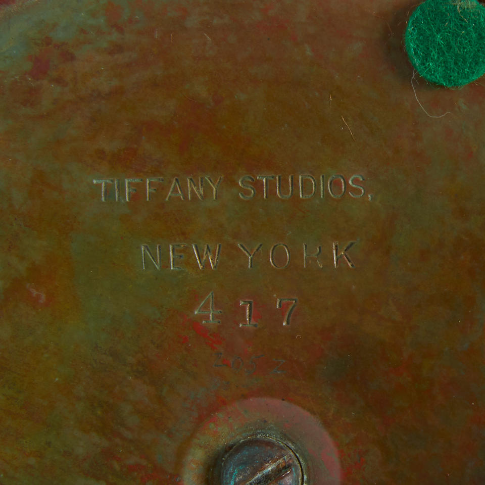 Tiffany Studios (1899-1930) Green Linenfold Counterbalance Desk Lampcirca 1910Favrile glass, patinated bronze, shade stamped 'TIFFANY STUDIOS NEW YORK 1941, underside of base stamped 'TIFFANY STUDIOS NEW YORK 417'height 14 1/2in (37cm); diameter of shade 6in (15cm)