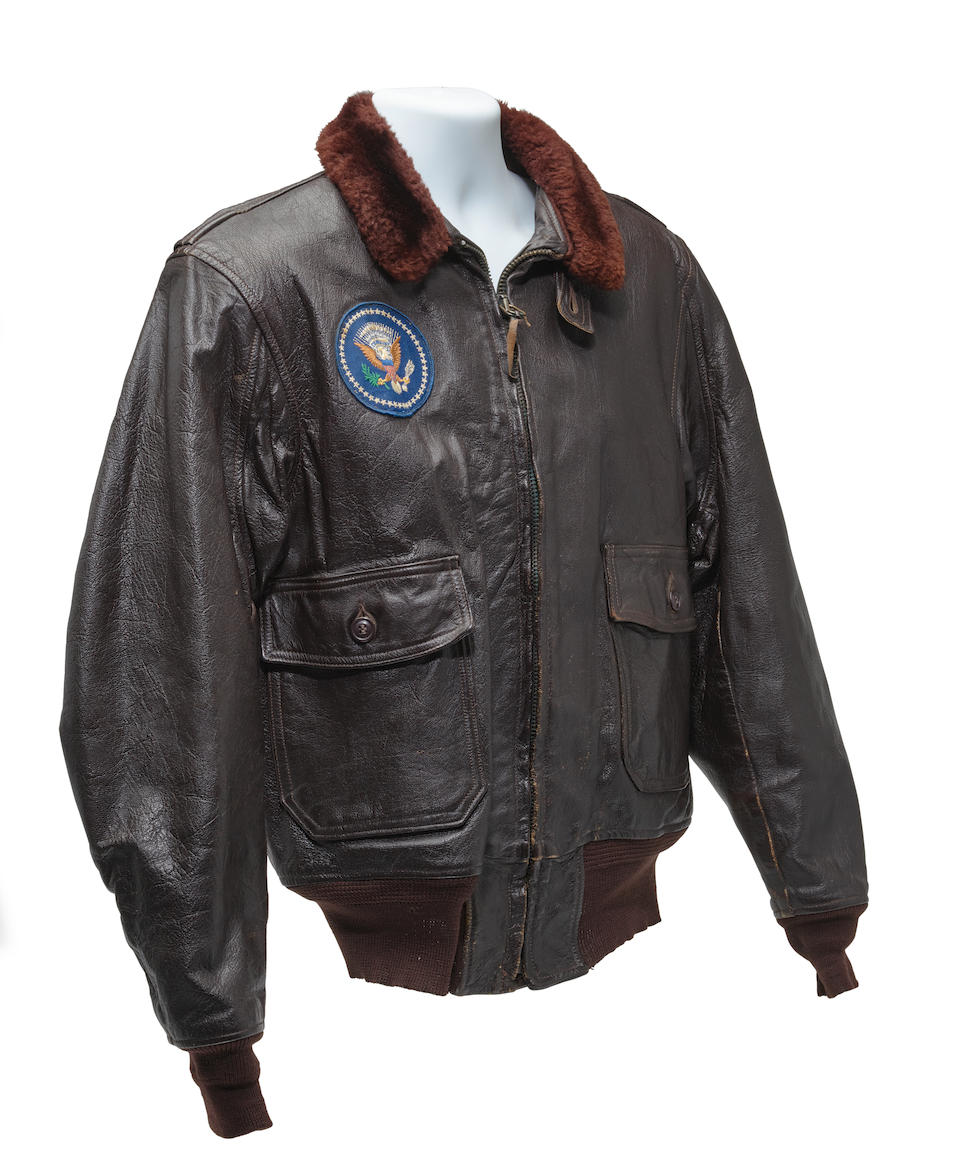 J.F.K.'S AIR FORCE ONE BOMBER JACKET GIVEN TO DAVID POWERS. An original U.S. Government issue G-1 flight jacket, with sewn patch of the Seal of the President of the United States over the right breast, originally owned by President John F. Kennedy and gifted to David Powers circa 1962-1963,