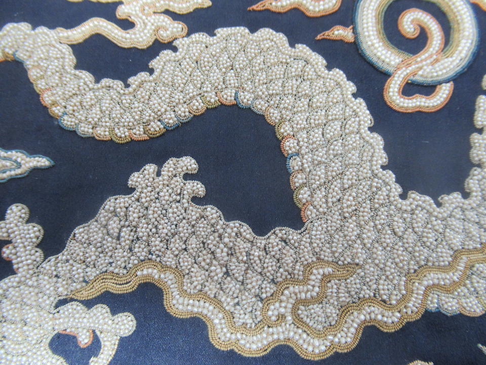 An embroidered silk and seed pearl dragon mirror case Early 18th Century
