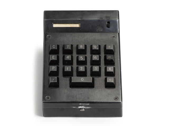 TEXAS INSTRUMENTS CAL-TECH PROTOTYPE HANDHELD CALCULATOR 1965-1967 Original milled aluminum hinged case finished in black, 155 x 105 x 43 mm, 18-button keypad including zero bar, number readout window, power switch, power charger plug, opens to reveal clear panel cover array of 4 Large-Scale Integration silicon "slices" and 3 shift register chips on a circuit board, thermal printer with thin paper roll, black plexiglass panel covering potted battery group and discretionary circuitry for power supply,