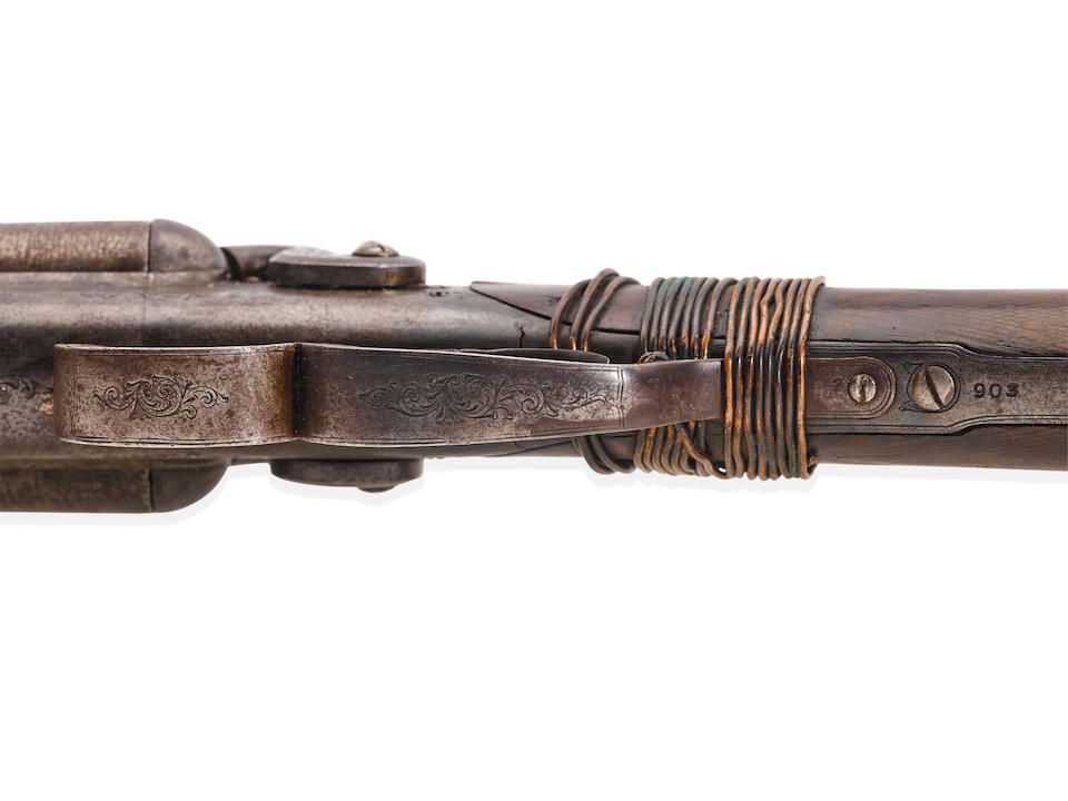 BILLY THE KID WHITNEY DOUBLE BARREL HAMMER SHOTGUN TAKEN FROM DEPUTY BOB OLINGER AND USED TO KILL HIM DURING BILLY THE KID'S DRAMATIC LINCOLN COUNTY COURTHOUSE ESCAPE ON APRIL 28, 1881.  Serial no. 903, circa 1880, 10 gauge 25 1/4 inch round brown Damascus twist pattern.