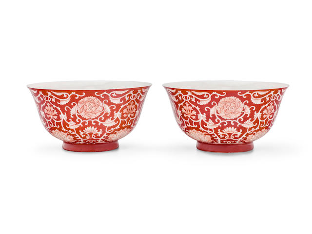 A pair of coral-ground reserve-decorated 'lotus' bowls Qianlong underglaze blue seal marks and of the period  (2)