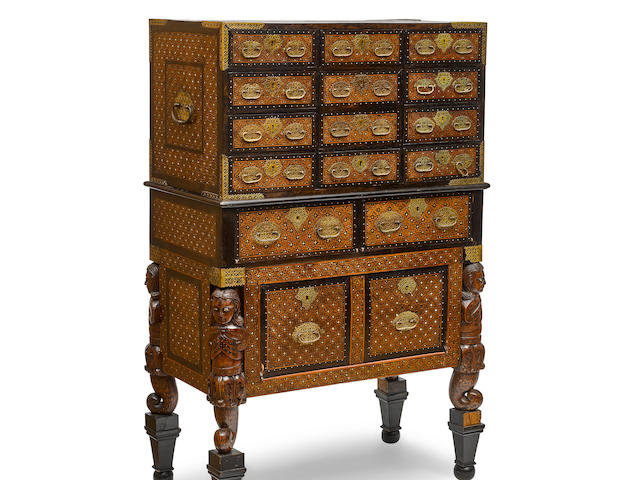 AN INDO-PORTUGESE CARVED TEAK, EBONY, AND BONE MARQUETRY CHEST ON CHESTGoa, 17th century