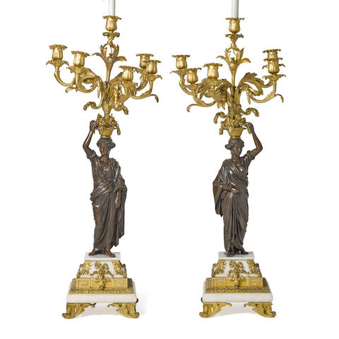 A PAIR OF NEOCLASSICAL STYLE GILT AND PATINATED BRONZE AND WHITE MARBLE FIGURAL CANDELABRA19th century