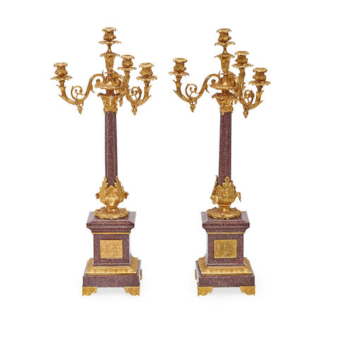 A PAIR OF EMPIRE STYLE PARCEL GILT AND PATINATED BRONZE AND GRANITE FOUR-LIGHT CANDELABRA