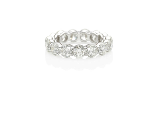 AN 18K WHITE GOLD AND DIAMOND ETERNITY BAND