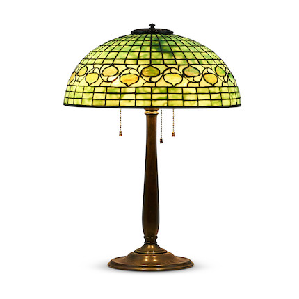 Tiffany Studios Vine Border Table Lamp, New York, New York, early 20th century, shade marked Tiffany Studios New York, dia. 16, Colonial base with stamped mark Tiffany Studios New York 534, three pull-chain sockets, total ht. 22 in.Literature Alistair Duncan, Tiffany Lamps and Metalwork (new edition), pp. 120-121. image 1