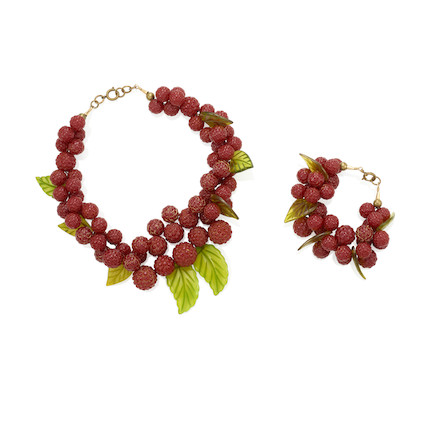A RARE BAKELITE RASPBERRY NECKLACE AND BRACELET SET each with red berry clusters and green translucent leavesthe length of the necklace 16in (40.7cm), the bracelet 6 1/2in (16.5cm) image 1