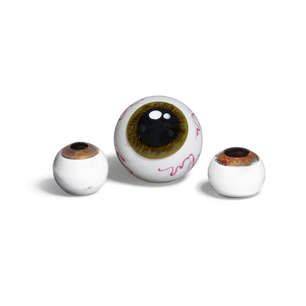 A GROUP OF THREE BLOWN GLASS PAPERWEIGHT EYEBALLS the two smaller by Zac Gorell (21st Century), each incised 'Z. GORELL' and dated, the larger unsignedwidth of largest 6 1/4in (15.8cm); diameter of smaller two 4 1/4in (10.7cm) image 1