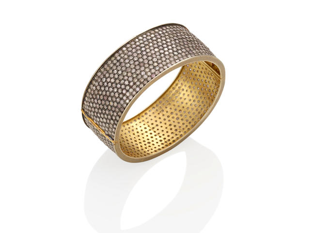 A SILVER-TOPPED GOLD AND DIAMOND HINGED BRACELET