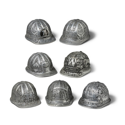 A GROUP OF SEVEN SOUTHEAST ASIAN HANDWROUGHT AND DECORATED ALUMINUM MINERS CAPS mid-20th centurylength 12in (30cm); width 9in (23cm) image 1