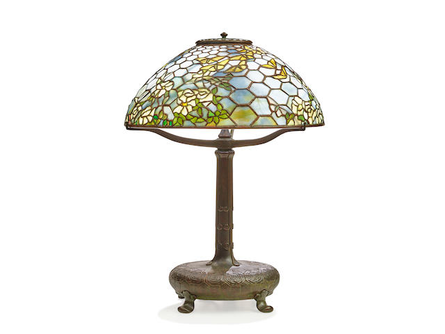 TIFFANY STUDIOS (1899-1930) Rare Rose and Butterfly Table Lampcirca 1910with Mud Turtle base, patinated bronze, leaded glass, shade tag-stamped 'TIFFANY STUDIOS NEW YORK', underside of base stamped 'TIFFANY STUDIOS NEW YORK 28618' with additional TG&D CO. mark height 22in (55.9cm); diameter of shade 16in (40.6cm)